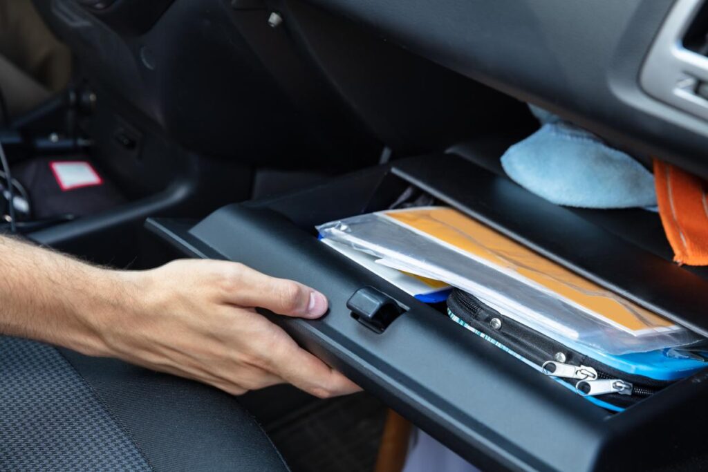 image of someone opening their glovebox