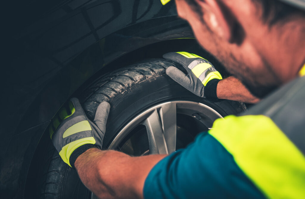 image of person adjusting the tire on a car
