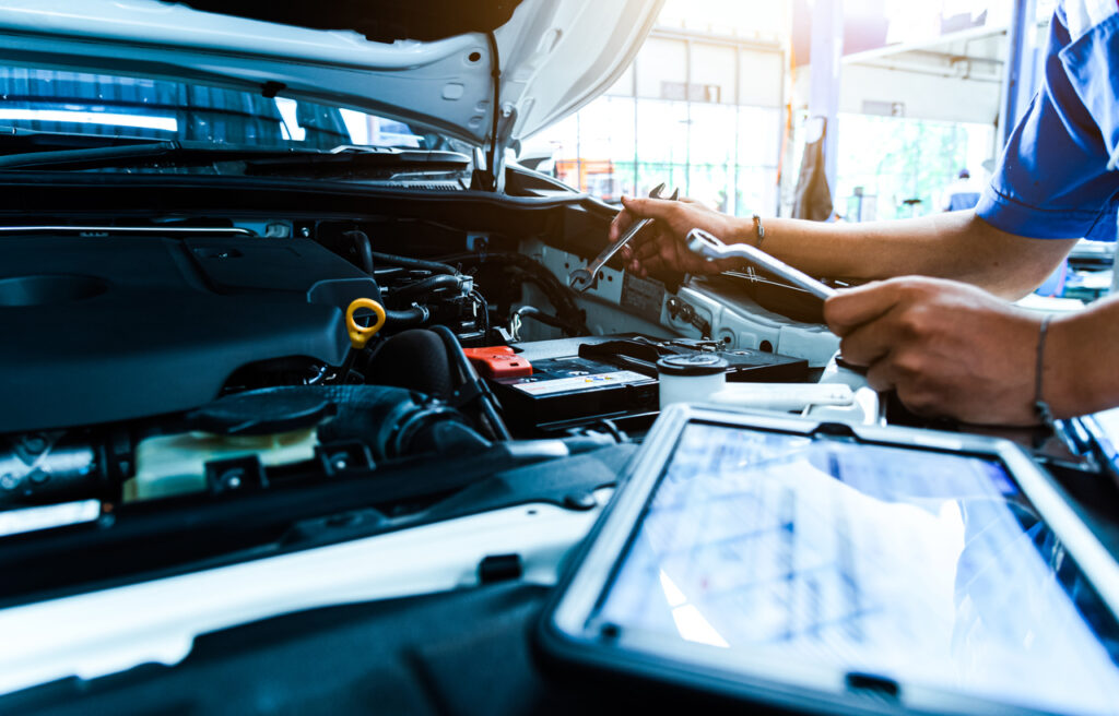 image of mechanic analyzing the interior of car engine